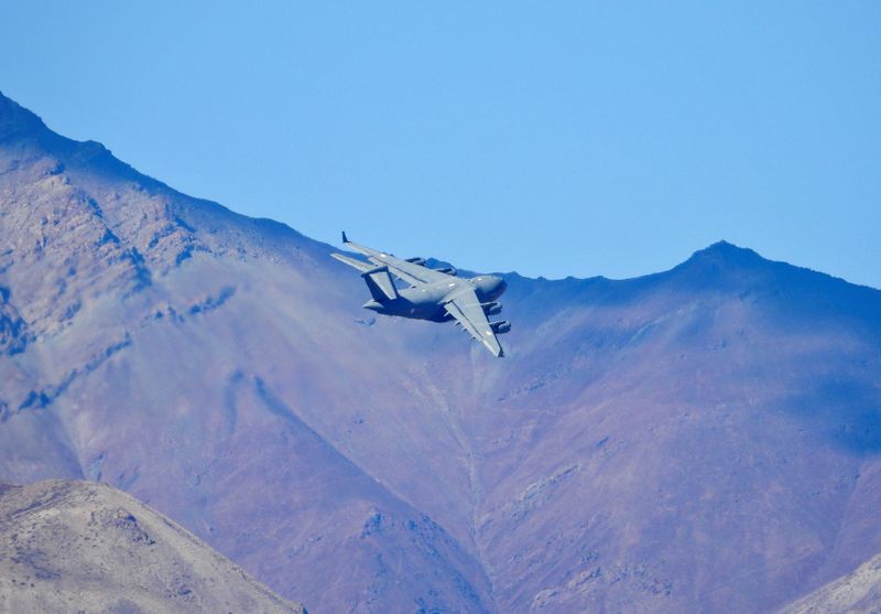 © Reuters. An Indian Air Force's (IAF) C-17 Globemaster transport plane flies over a mountain range in Leh