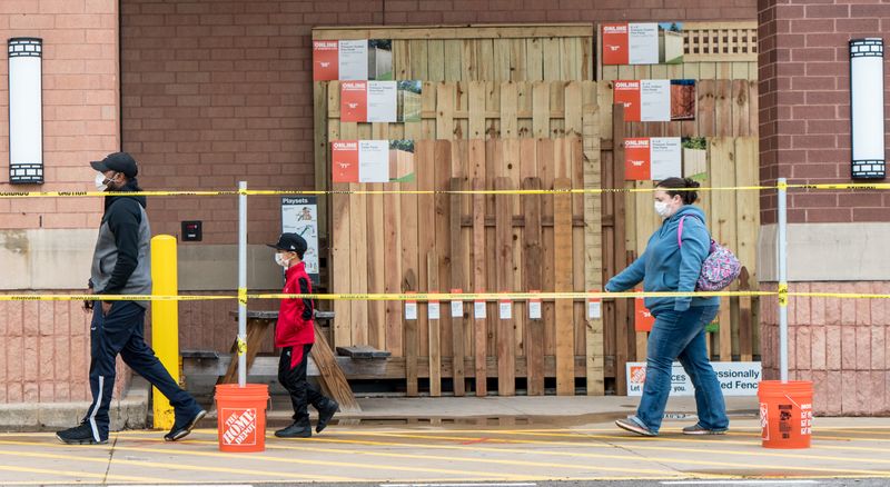 &copy; Reuters. FILE PHOTO:  Shoppers line up to enter a Home Depot building supplies store as they practice social distancing in St Louis