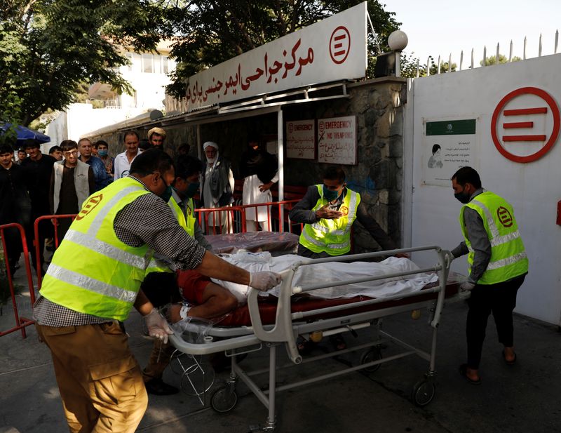 &copy; Reuters. Afghan men carry an injured to a hospital after a blast in Kabul, Afghanistan