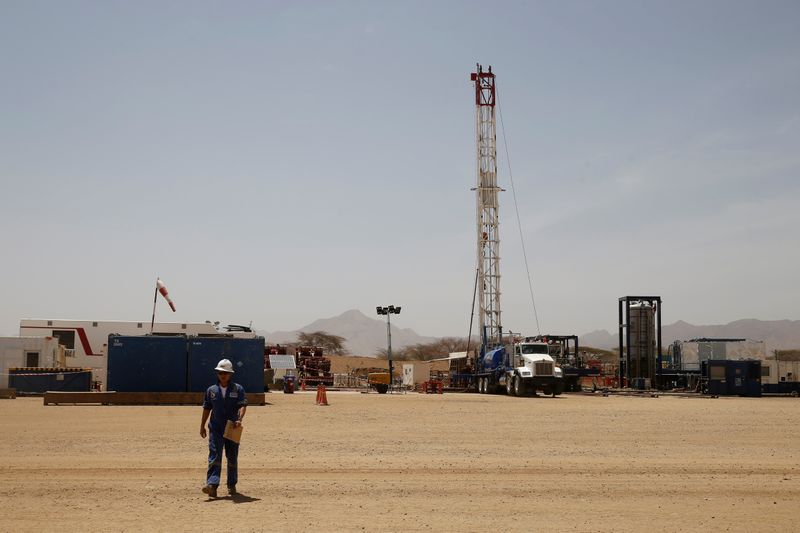 &copy; Reuters. FILE PHOTO: Worker walks at a Tullow Oil explorational drilling site in Lokichar