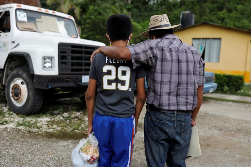 &copy; Reuters. Juan embraces his disabled 12-year-old son Gustavo, who was expelled by U.S. authorities to Guatemala under an emergency health order, during their reunion in Peten