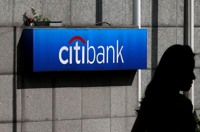 &copy; Reuters. FILE PHOTO: A woman walks past a Citibank logo displayed outside the Citibank Plaza in Hong Kong