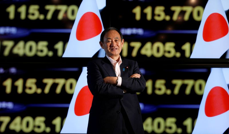 &copy; Reuters. FILE PHOTO : Japan&apos;s Chief Cabinet Secretary Yoshihide Suga poses for a photograph in front of television screens during a Thomson Reuters Newsmaker event in Tokyo
