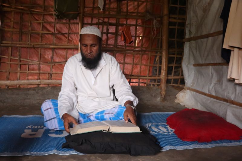 &copy; Reuters. Mohammed Rofiq, a Rohingya refugee, reads Islamic scripture in his home in Kutupalong refugee camp, in Cox&apos;s Bazar