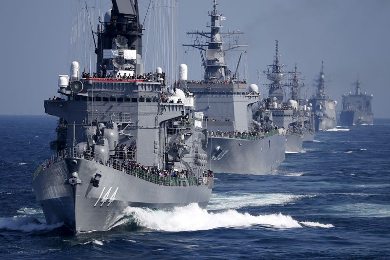 &copy; Reuters. FILE PHOTO: JMSDF destroyer Kurama, which is carrying Japan&apos;s PM Abe,  leads the JMSDF fleet during its fleet review at Sagami Bay, off Yokosuka