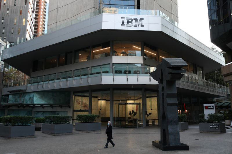 &copy; Reuters. A man wearing a protective mask walks past an office building with IBM logo amidst the easing of the coronavirus disease (COVID-19) restrictions in Sydney
