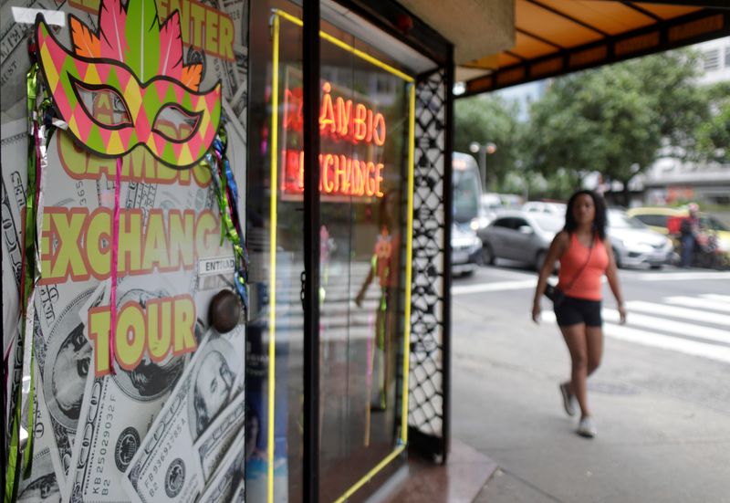 &copy; Reuters. A woman walks past a money exchange office in Rio de Janeiro