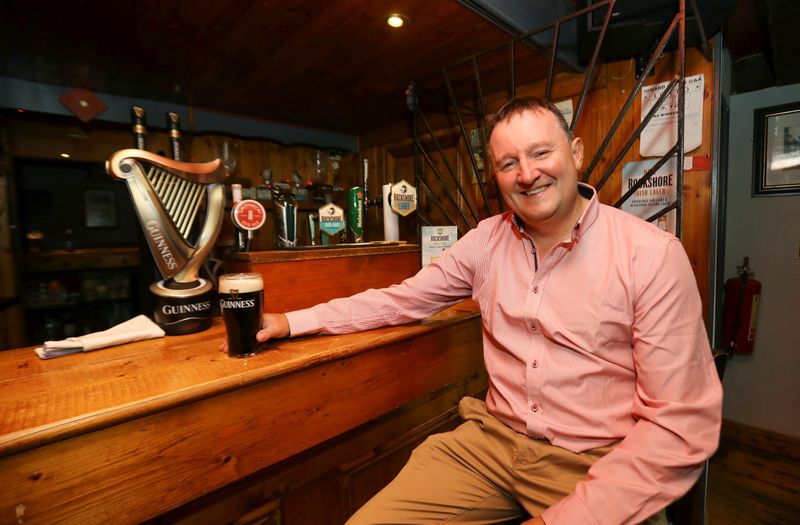 &copy; Reuters. Publican Paul Moynihan prepares for reopening his pub in Donard, County Wicklow, Ireland
