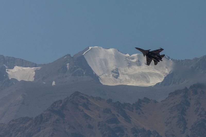 © Reuters. An Indian fighter plane flies over a mountain range in Leh