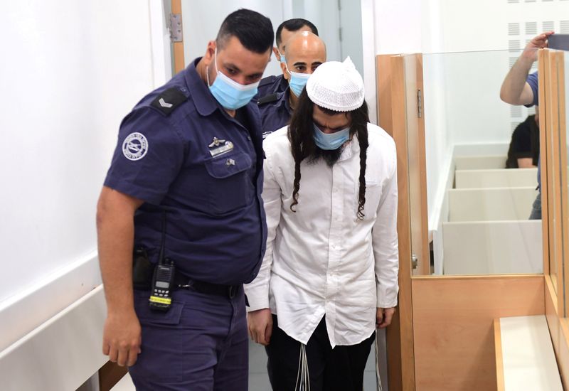 &copy; Reuters. FILE PHOTO: Amiram Ben-Uliel is brought for a verdict in the case of the 2015 arson attack, which killed a Palestinian toddler and his parents in the Israeli-occupied West Bank village of Duma, at the Central Lod District Court in Lod