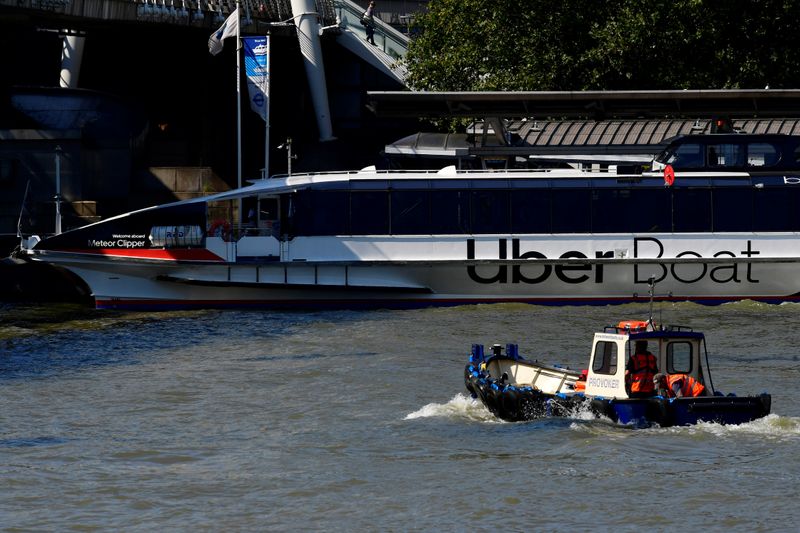 &copy; Reuters. Uber signage is seen on the side of a river taxi on the river Thames, in London