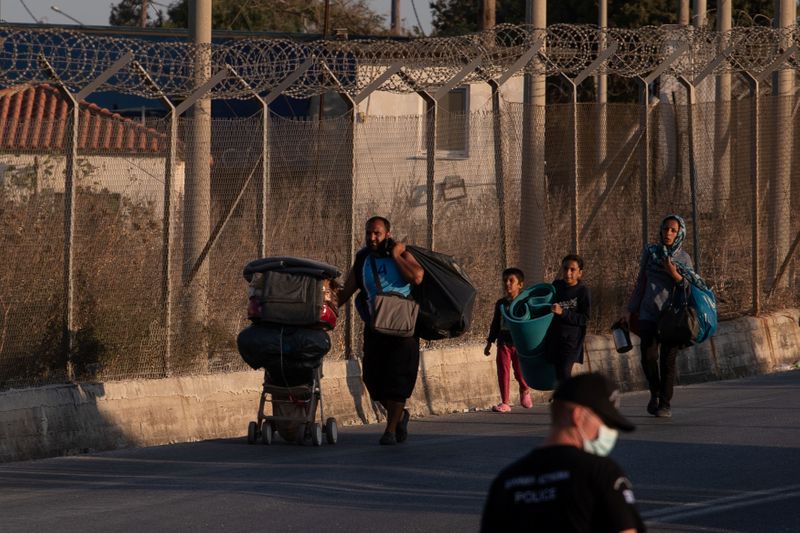 &copy; Reuters. A family from the destroyed Moria camp for refugees and migrants arrives at a new temporary camp, on the island of Lesbos