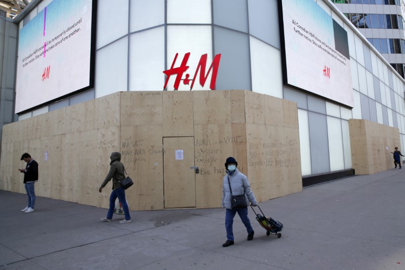 &copy; Reuters. FILE PHOTO: Woman passes closed H&amp;M store during the global outbreak of coronavirus disease in Toronto