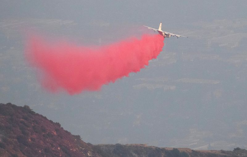 &copy; Reuters. A P2V Neptune air tanker drops fire retardant on a hill near Mount Wilson Observatory while battling the Bobcat Fire in Los Angeles