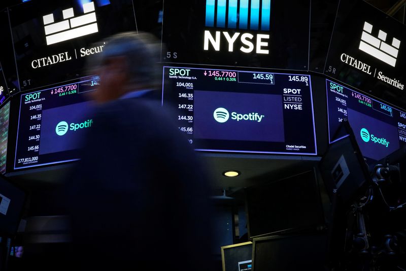 &copy; Reuters. A trader passes by screens showing Spotify on the floor at the NYSE in New York