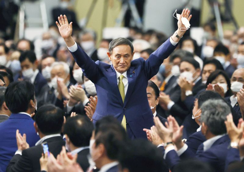 &copy; Reuters. Japanese Chief Cabinet Secretary Suga gestures as he is elected as new head of the ruling party at the Liberal Democratic Party&apos;s (LDP) leadership election in Tokyo