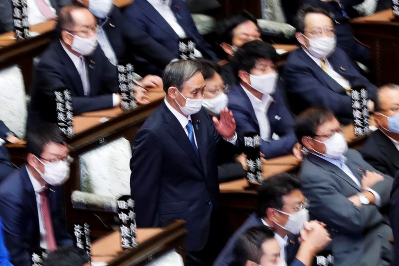 &copy; Reuters. Japan&apos;s Chief Cabinet Secretary Yoshihide Suga walks to cast a vote to elect the new prime minister at the Lower House of the Parliament in Tokyo