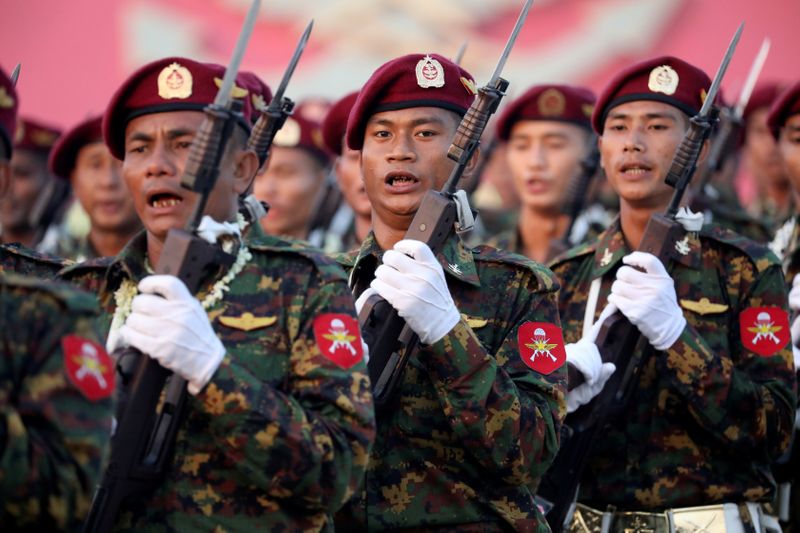 &copy; Reuters. FILE PHOTO: Soldiers take part in a military parade to mark the 74th Armed Forces Day in the capital Naypyitaw