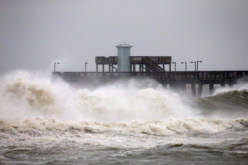 &copy; Reuters. Waves crash along a pier as Hurricane Sally approaches in Gulf Shores