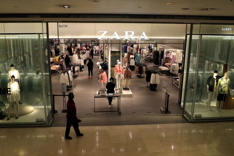 &copy; Reuters. FILE PHOTO: Staff wearing protective mask waits for customers at the entrance of a Zara store, amid the coronavirus disease (COVID-19) outbreak in Kuala Lumpur