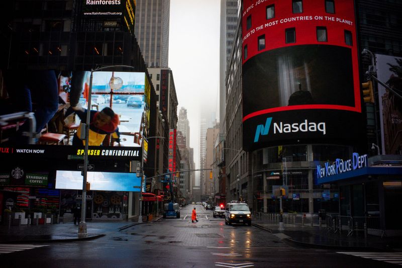 &copy; Reuters. FILE PHOTO: A man walks near Nasdaq MarketSite in an empty Times Square