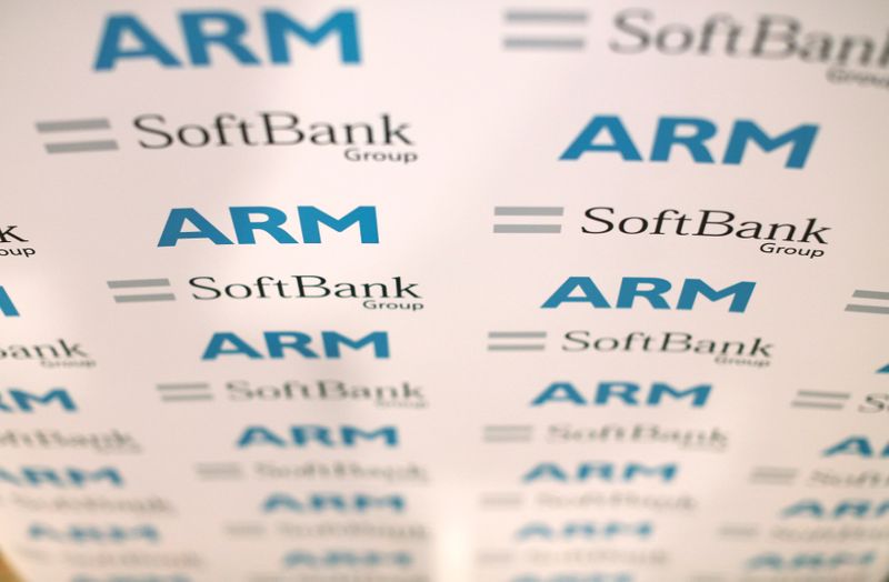 © Reuters. FILE PHOTO: An ARM and SoftBank Group branded board is displayed at a news conference in London