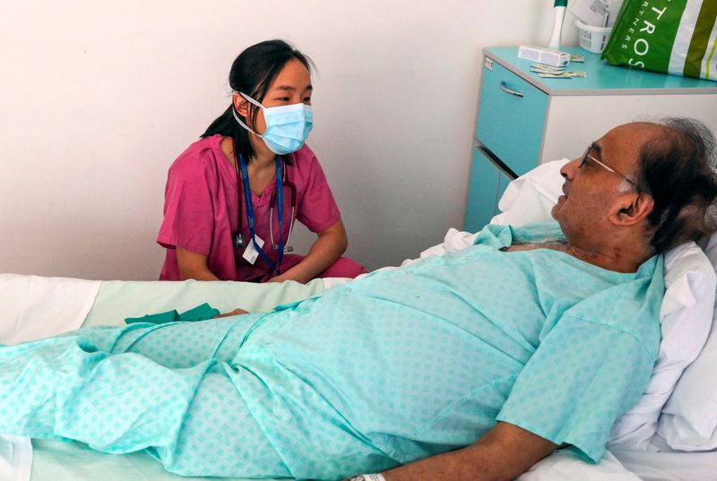 &copy; Reuters. Patient Hitesh Patel talks to doctor Jasmine Gan on a COVID-19 recovery ward at Wexham Park Hospital near Slough
