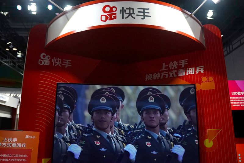 &copy; Reuters. FILE PHOTO: A screen showing footage of a military parade is seen at a booth of Chinese video-streaming startup Kuaishou at the 2020 China International Fair for Trade in Services