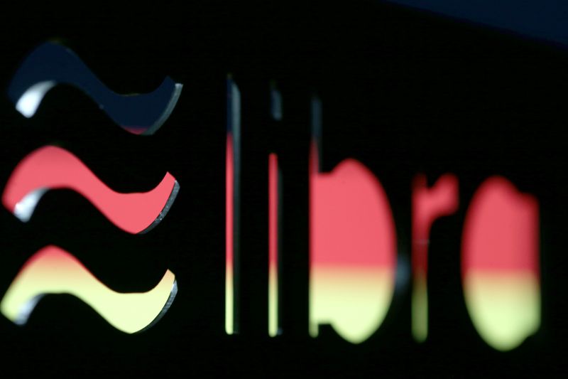 &copy; Reuters. A 3D-printed Facebook Libra cryptocurrency logo is seen in front of displayed German flag in this illustration taken