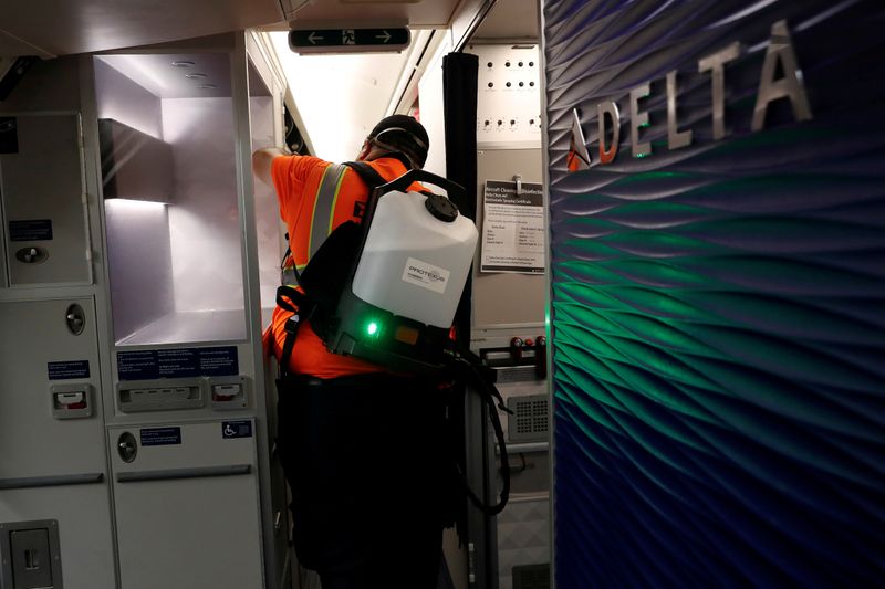 &copy; Reuters. A Delta Air Lines pre-flight cleaning crew member uses an electrostatic disinfection device to clean an aircraft at JFK International Airport in New York