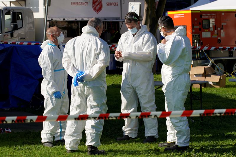 &copy; Reuters. Response personnel prepare to enter a public housing tower, locked down in response to a COVID-19 outbreak, in Melbourne