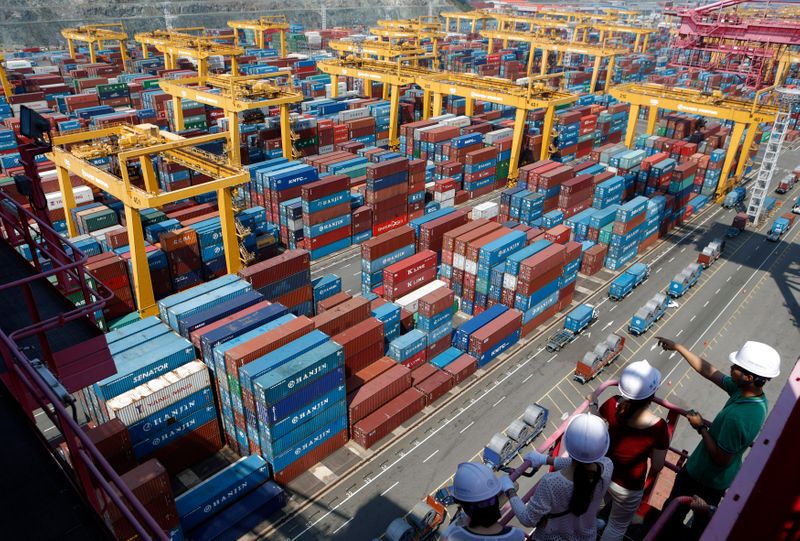 &copy; Reuters. People look at Hanjin Shipping&apos;s container terminal at the Busan New Port in Busan