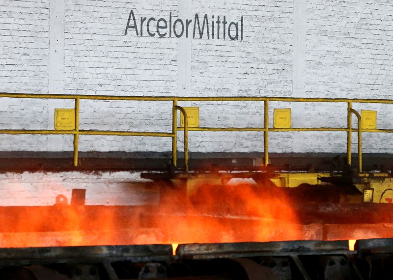 &copy; Reuters. The logo of ArcelorMittal is pictured in front of heat rising from a red-hot steel plate at the ArcelorMittal steel plant in Ghent