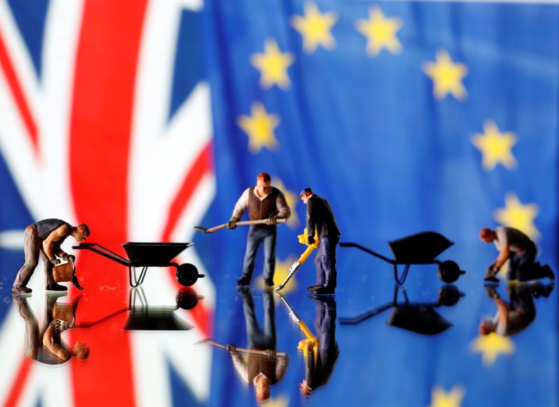 © Reuters. Small toy figures are seen in front of UK and European Union displayed flags in this illustration picture,