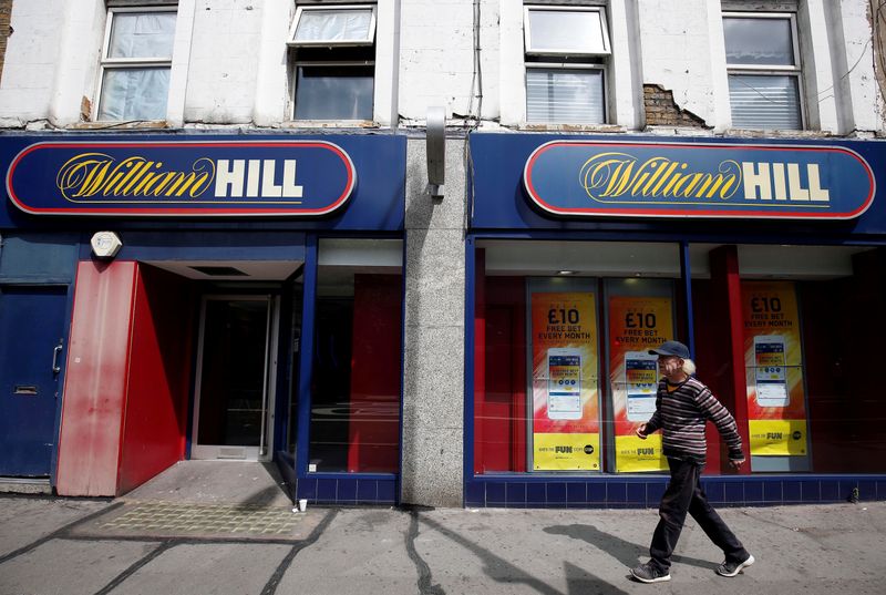 &copy; Reuters. FILE PHOTO: A pedestrian walks past a William Hill betting shop in London
