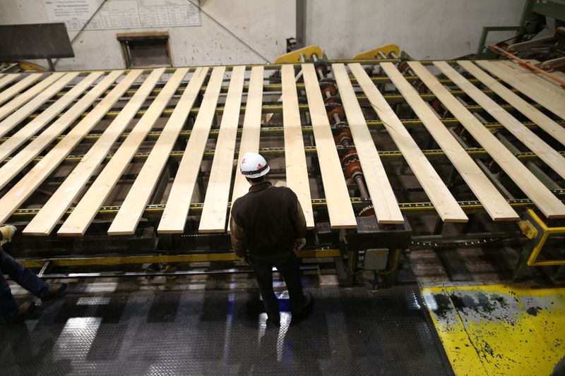 &copy; Reuters. A worker inspects lumber on a conveyor belt at West Fraser Pacific Inland Resources sawmill in Smithers