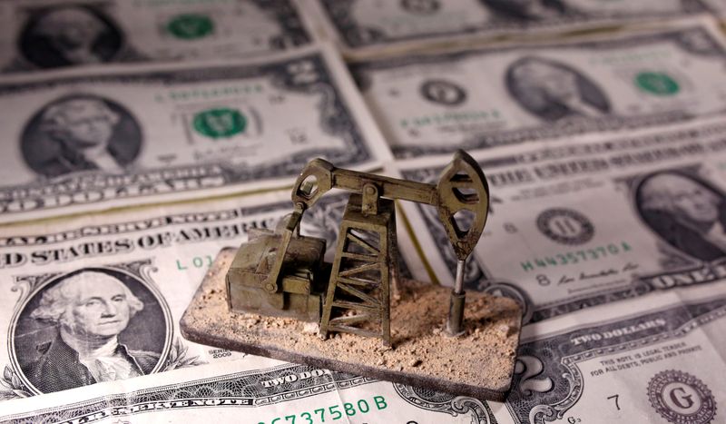 &copy; Reuters. A 3D printed oil pump jack is placed on dollar banknotes in this illustration picture