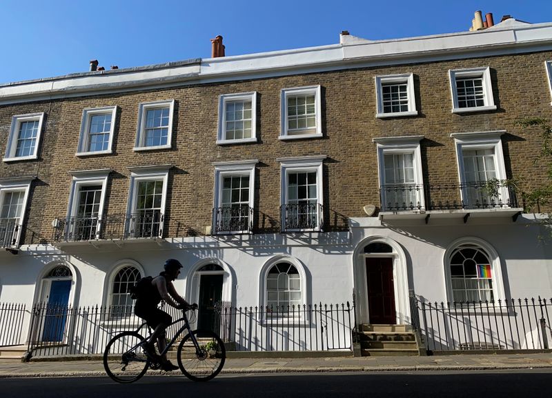 &copy; Reuters. A cyclist rides past houses on a street in Islington, London
