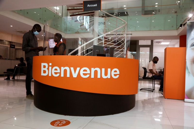 &copy; Reuters. People are pictured at a bank of the French mobile operator Orange in Abidjan, Ivory Coast