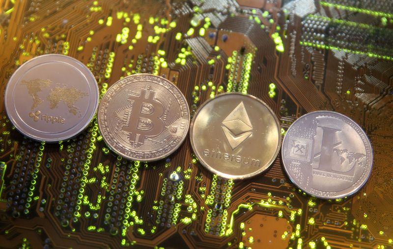 &copy; Reuters. FILE PHOTO: Representations of the Ripple, Bitcoin, Etherum and Litecoin virtual currencies are seen on motherboard in this illustration picture