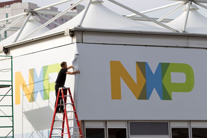 &copy; Reuters. A man works on a tent for NXP Semiconductors in preparation for the 2015 International Consumer Electronics Show (CES) at Las Vegas Convention Center in Las Vegas