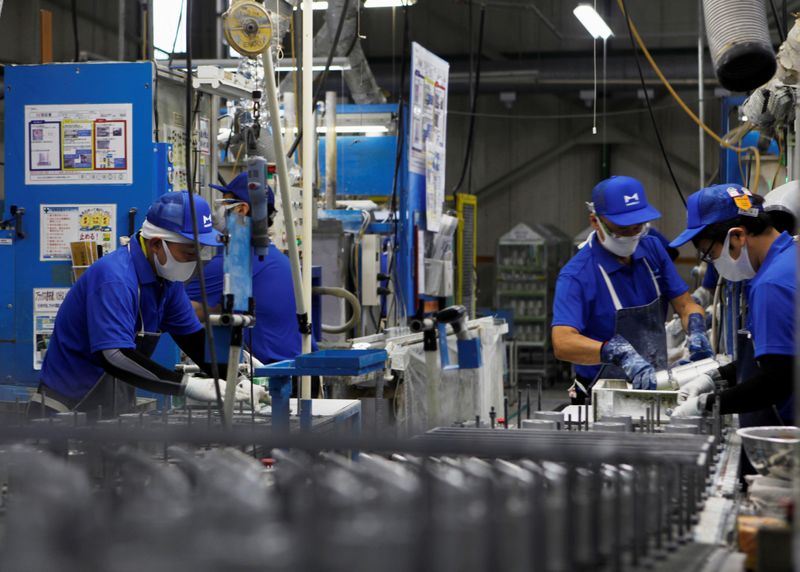 &copy; Reuters. FILE PHOTO: Workers wearing protective face masks are seen along the assembly line, amid the coronavirus disease (COVID-19) outbreak, at Marelli&apos;s factory in Ora Town