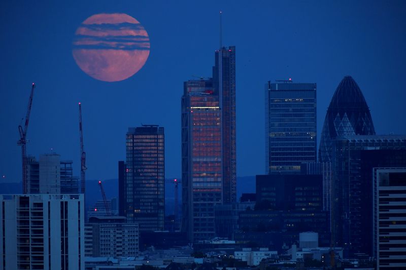 &copy; Reuters. The full moon is seen rising over the City of London financial district in London