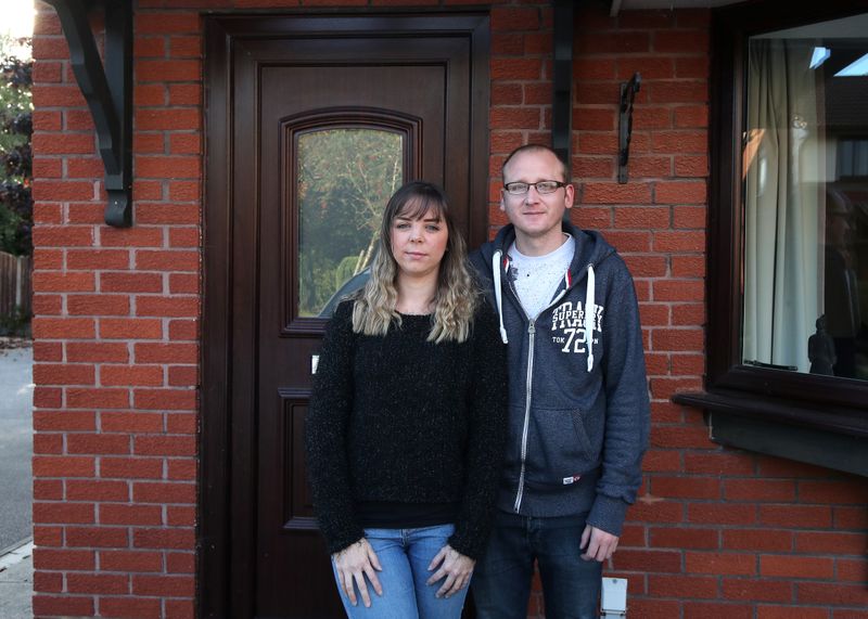 &copy; Reuters. Claire Tomlinson and her partner Ricky Collier pose for a portrait in Sandbach