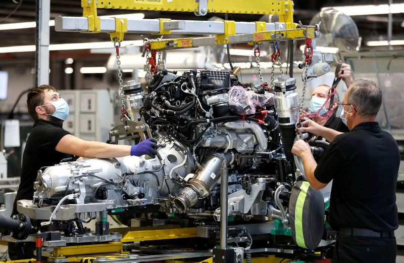 © Reuters. FILE PHOTO: Technicians work on a Rolls-Royce engine prior to it being installed in a car on the production line of the Rolls-Royce Goodwood factory, near Chichester