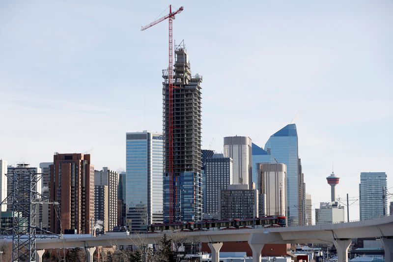 &copy; Reuters. Workers guide equipment at a condominium development in Calgary