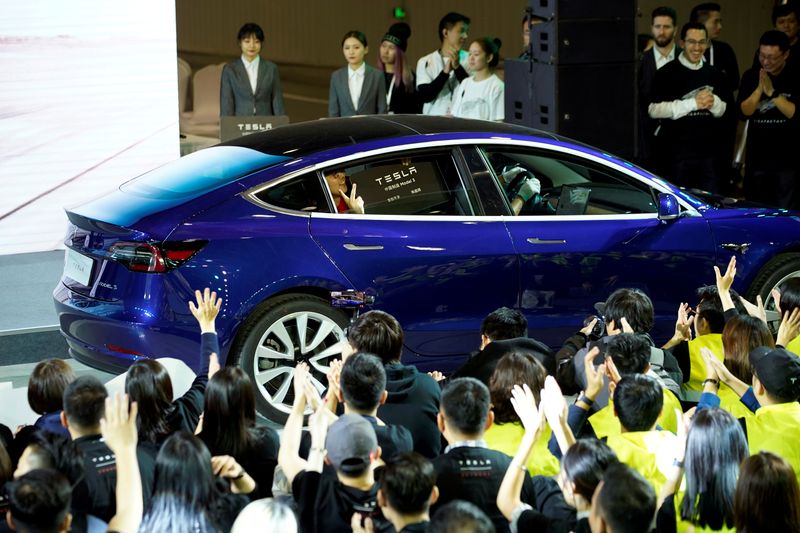 © Reuters. FILE PHOTO: Tesla China-made Model 3 vehicle owner sits inside a car during a delivery event at Tesla's Shanghai factory