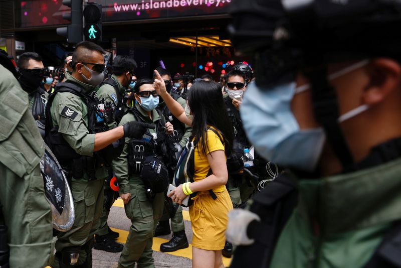 © Reuters. Pro-democracy protester argues with police before a protest in Hong Kong
