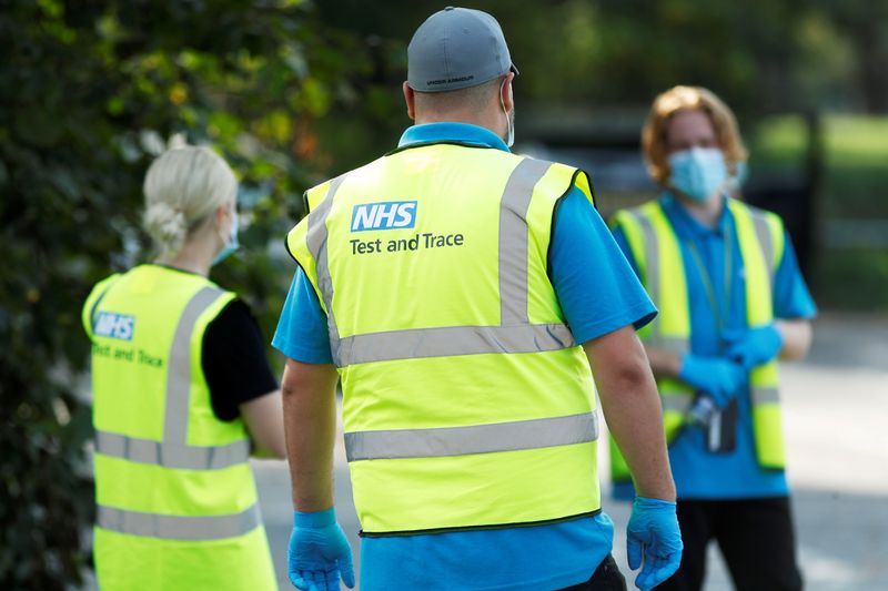 &copy; Reuters. FILE PHOTO: NHS Test and Trace workers are seen at a test station in Richmond-Upon-Thames