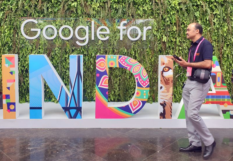 &copy; Reuters. FILE PHOTO: A man walks past the sign of &quot;Google for India&quot;, the company&apos;s annual technology event in New Delhi